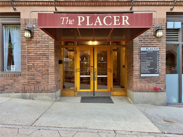 doorway to property with brick siding