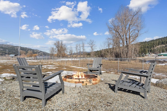 view of yard featuring fence and a fire pit