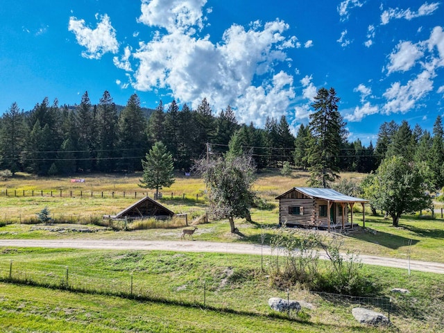 view of yard featuring a rural view and fence