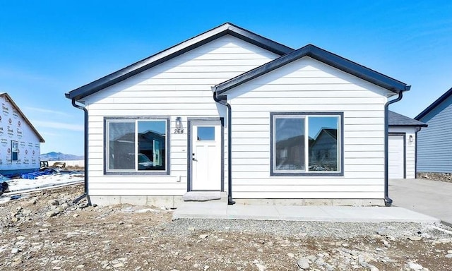 bungalow-style home featuring concrete driveway and an attached garage