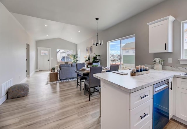 kitchen featuring light countertops, visible vents, open floor plan, white cabinetry, and dishwasher