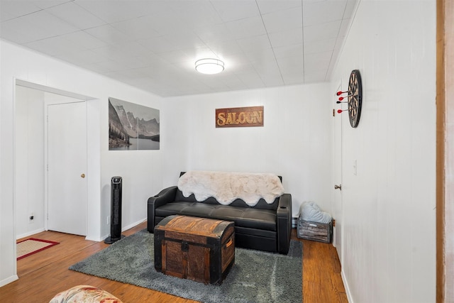 living area featuring baseboards and wood finished floors