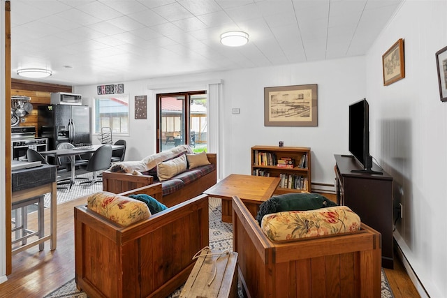 living room with light wood-style floors and baseboard heating