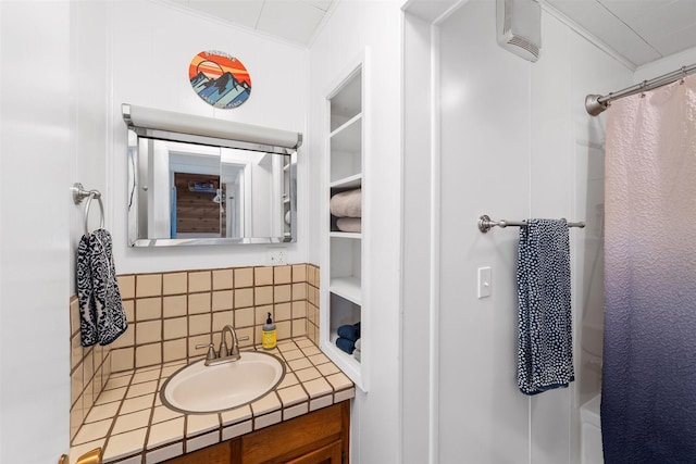 bathroom with a shower with curtain, tasteful backsplash, ornamental molding, and vanity