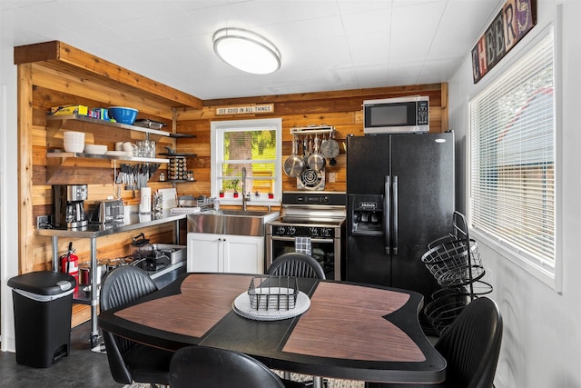 dining area featuring wooden walls