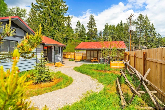 view of yard featuring driveway and a fenced backyard