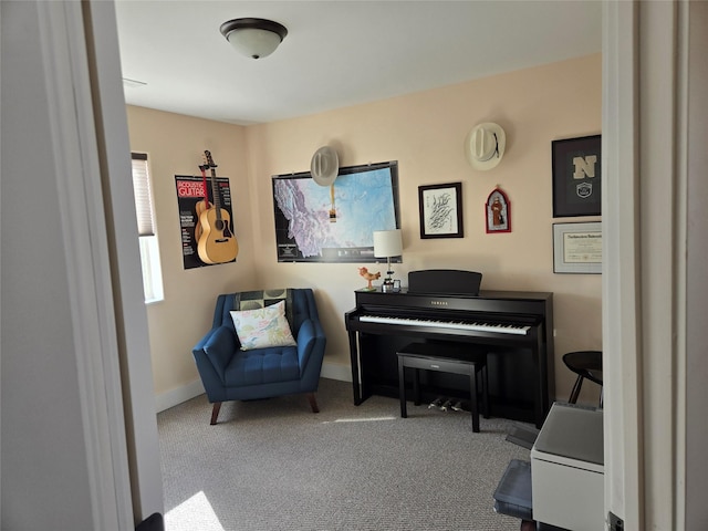 sitting room featuring carpet flooring and baseboards