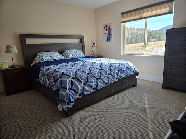 carpeted bedroom featuring baseboards