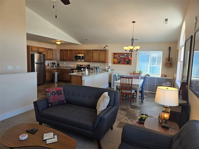 living area featuring ceiling fan with notable chandelier, high vaulted ceiling, visible vents, and baseboards