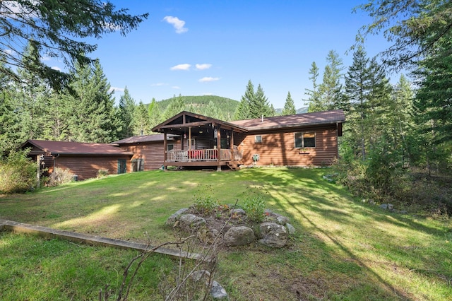 view of front of home featuring a front yard and a wooden deck