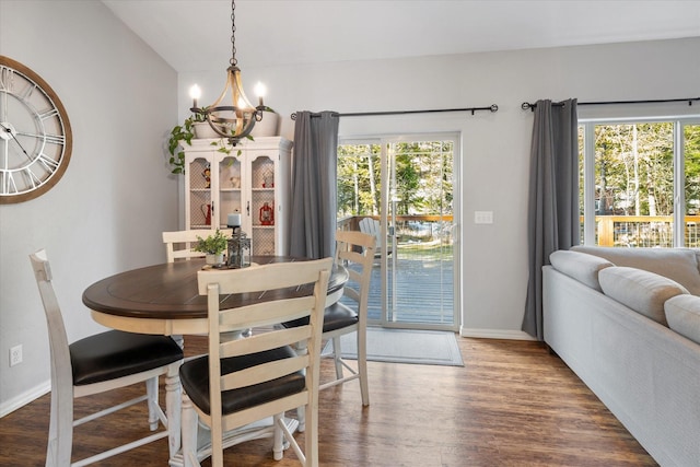 dining area with a chandelier, baseboards, and wood finished floors