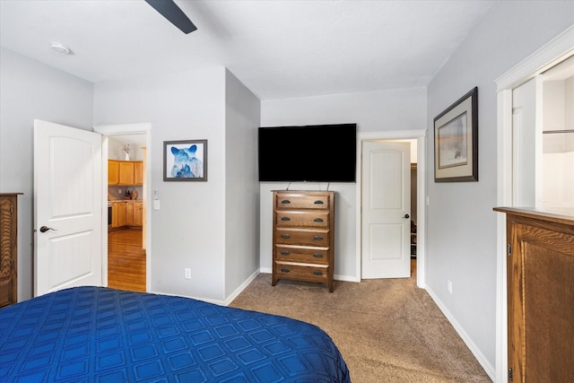 carpeted bedroom with a ceiling fan and baseboards