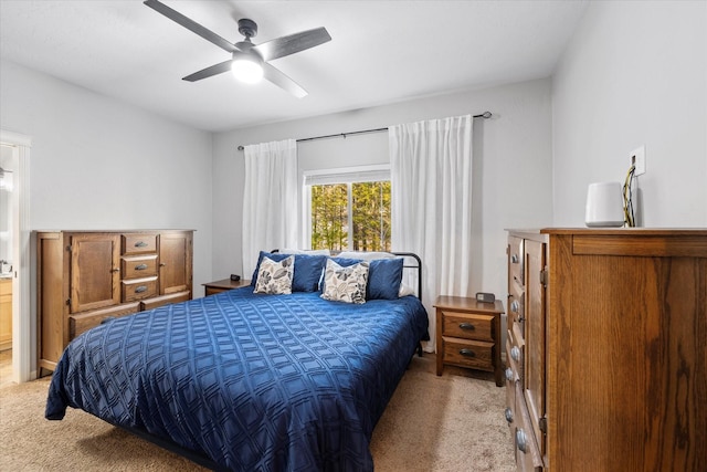 bedroom with a ceiling fan and light carpet