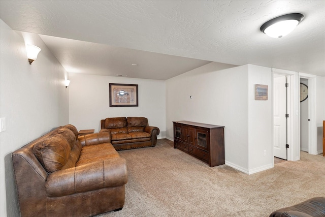 living area featuring baseboards, a textured ceiling, and light colored carpet