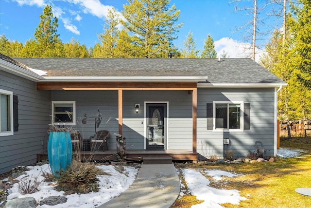 view of front of property with covered porch and a shingled roof