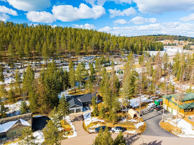 drone / aerial view featuring a forest view