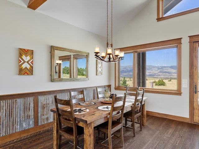 dining room featuring a wealth of natural light, vaulted ceiling, baseboards, and wood finished floors