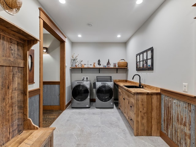 laundry area with laundry area, recessed lighting, a sink, and washing machine and clothes dryer