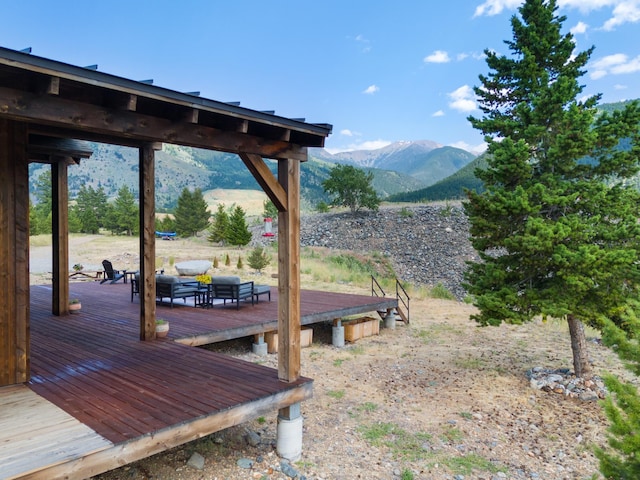 view of yard featuring a deck with mountain view