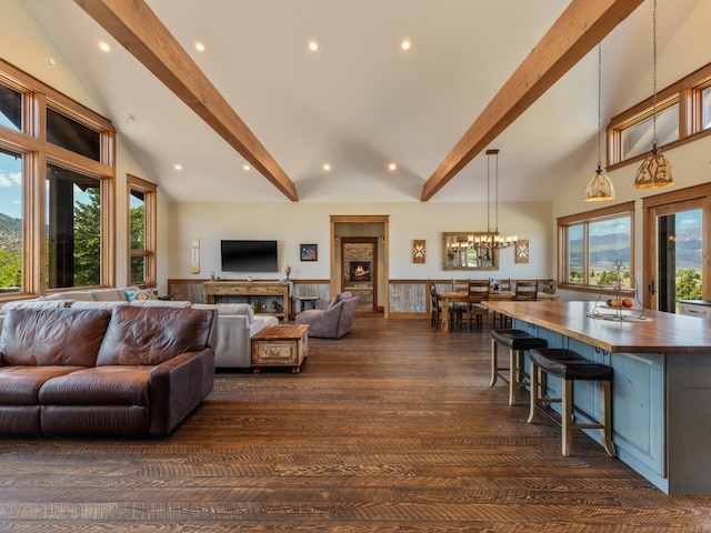 living room with a chandelier, recessed lighting, a wainscoted wall, beamed ceiling, and dark wood finished floors