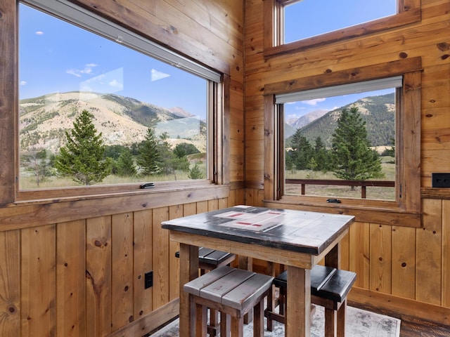 dining space with wood walls and a mountain view