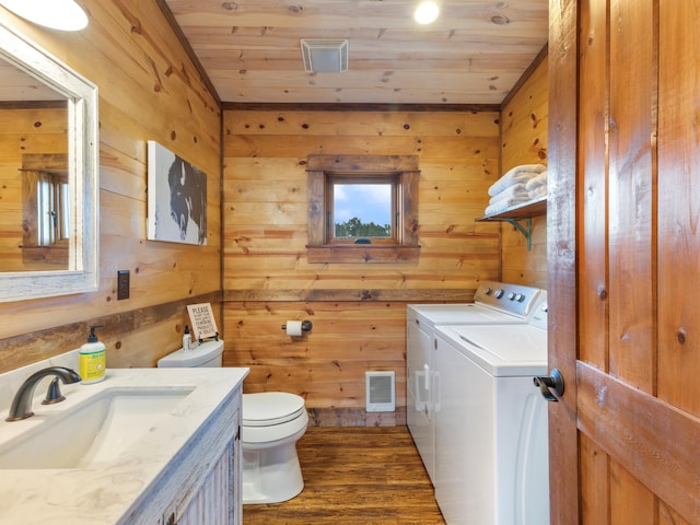 bathroom featuring visible vents, toilet, wood ceiling, separate washer and dryer, and wood finished floors