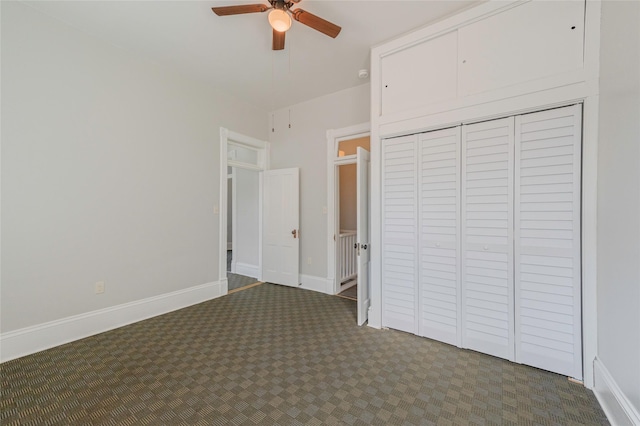 unfurnished bedroom featuring carpet, a closet, ceiling fan, and baseboards