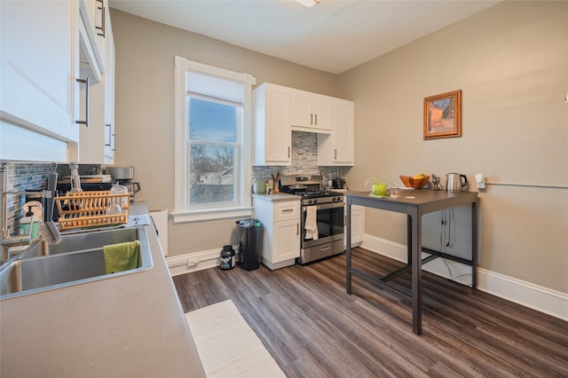 kitchen featuring white cabinets, stainless steel gas range, dark wood finished floors, and a sink