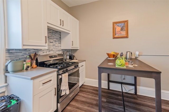 kitchen featuring white cabinetry, baseboards, light countertops, backsplash, and gas stove