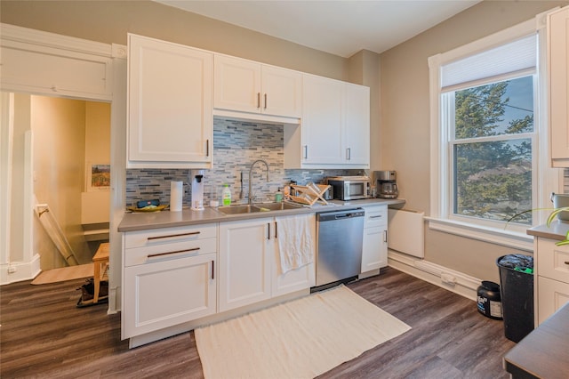 kitchen with dark wood-style floors, backsplash, white cabinets, a sink, and dishwasher