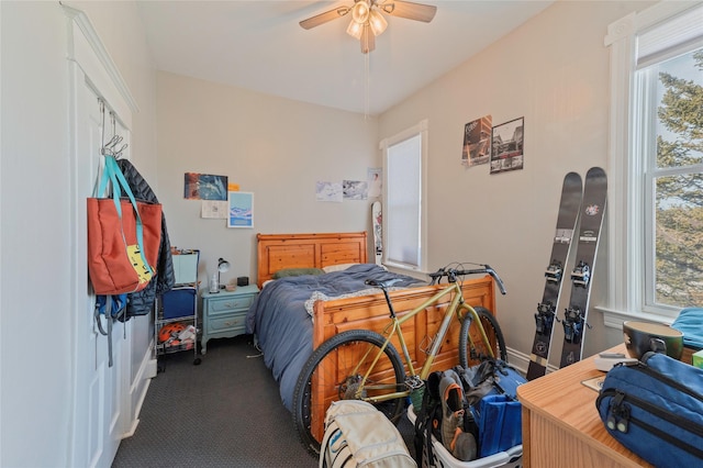 bedroom with carpet floors, baseboards, and a ceiling fan