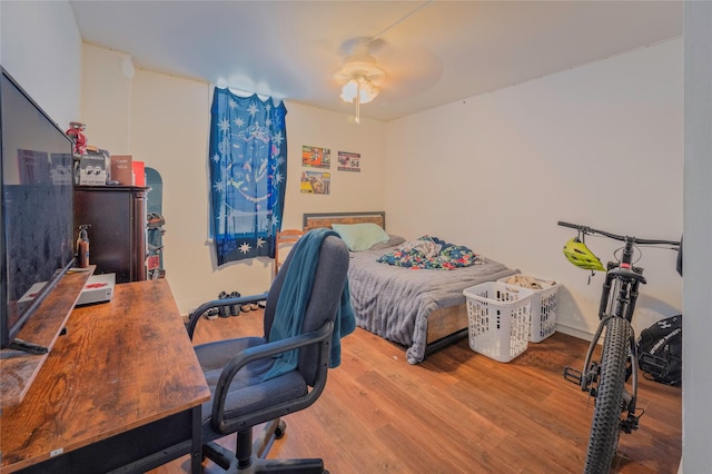 bedroom featuring a ceiling fan and wood finished floors