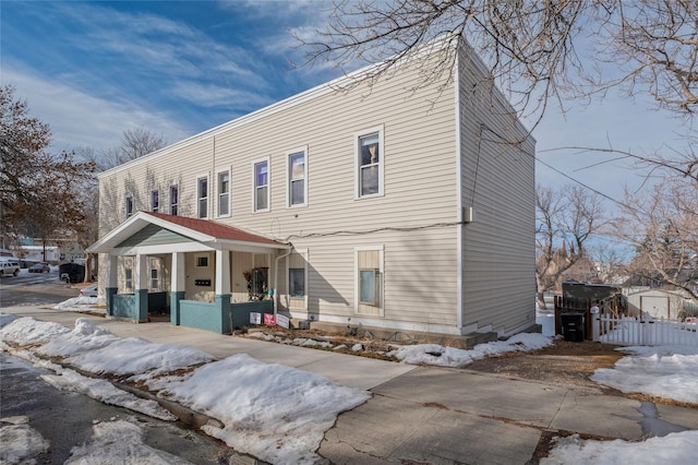 view of front of house with a porch and fence