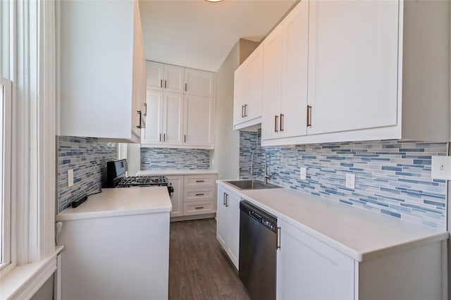 kitchen with tasteful backsplash, light countertops, appliances with stainless steel finishes, white cabinetry, and a sink