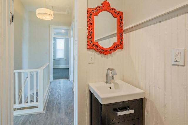 bathroom with wood finished floors and vanity