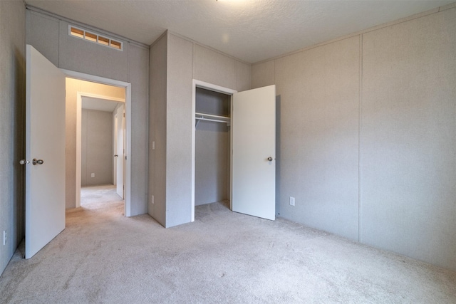 unfurnished bedroom with carpet floors and a closet