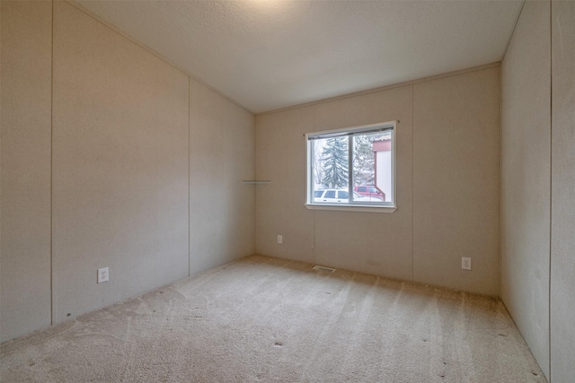 spare room with carpet and visible vents