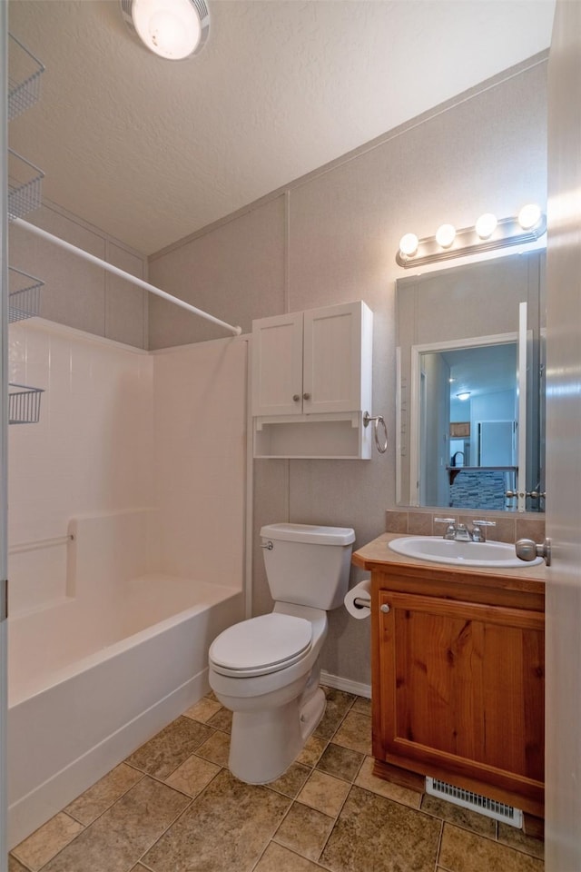 bathroom featuring shower / washtub combination, visible vents, toilet, vanity, and a textured ceiling