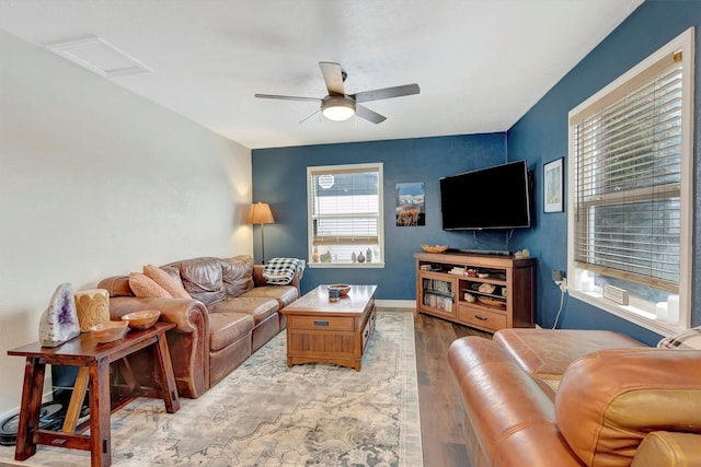 living room with ceiling fan, wood finished floors, attic access, and baseboards