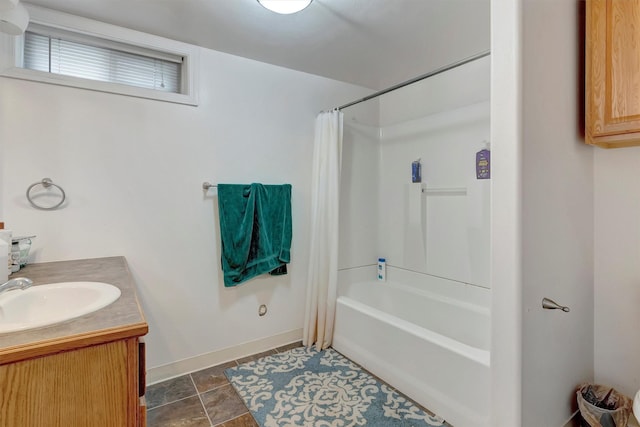 full bath featuring tile patterned flooring, shower / bath combo, baseboards, and vanity