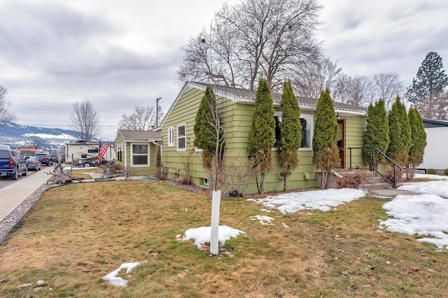 view of side of home featuring a lawn