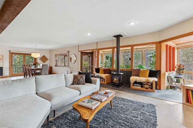 456 Peaceful Dr, Bigfork, MT 59911 - living room featuring a wood stove, plenty of natural light, and recessed lighting