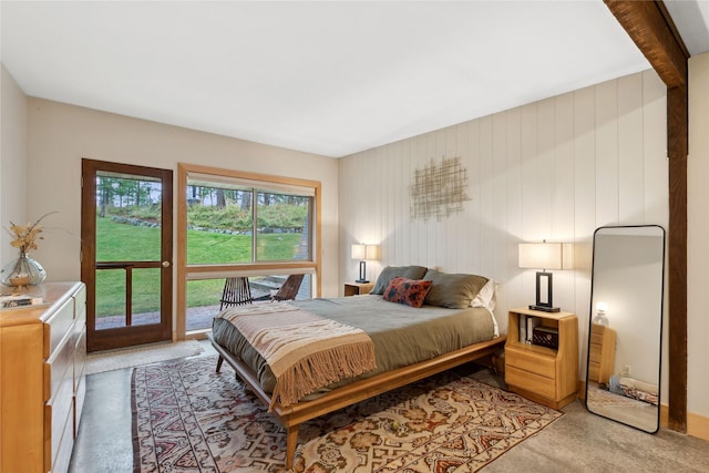 bedroom featuring concrete floors and access to exterior