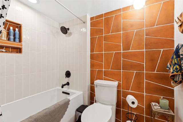 bathroom with toilet, tile walls, and shower / tub combination