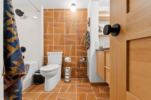 456 Peaceful Dr, Bigfork, MT 59911 - full bathroom with tile patterned flooring, tile walls, and shower / bath combo with shower curtain