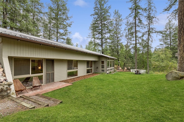 456 Peaceful Dr, Bigfork, MT 59911 - view of green lawn featuring a patio area