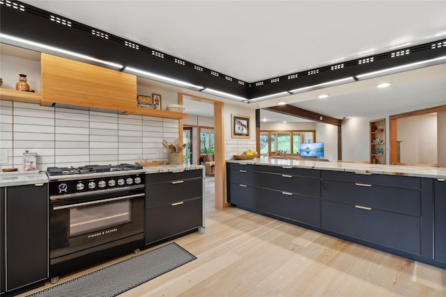 kitchen with open shelves, custom exhaust hood, black range with gas stovetop, and light wood-style flooring