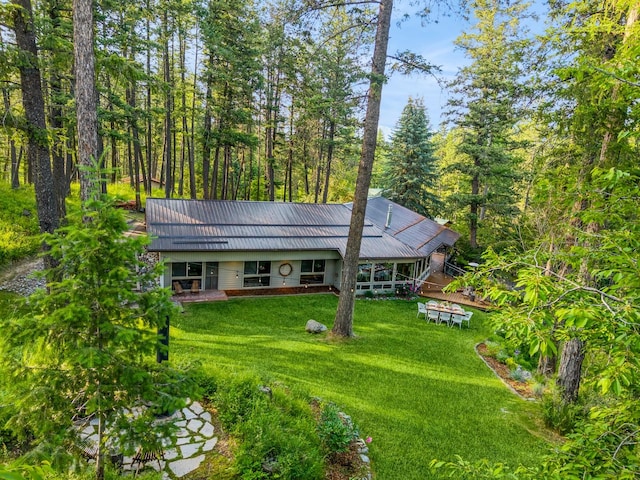 456 Peaceful Dr, Bigfork, MT 59911 - view of front of home featuring a front yard, a metal roof, and a wooded view