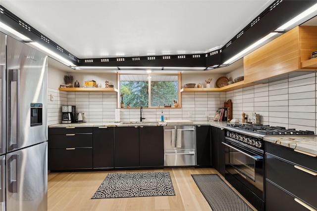 456 Peaceful Dr, Bigfork, MT 59911 - kitchen featuring appliances with stainless steel finishes, open shelves, dark cabinets, and decorative backsplash