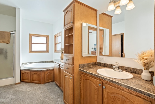 bathroom featuring a stall shower, vanity, and a bath